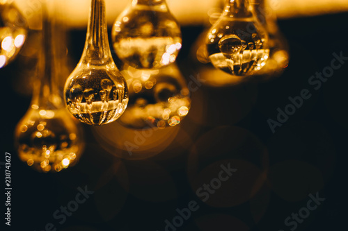  abstract blurry glowing lights of a crystal lamp. Warm light glass.
