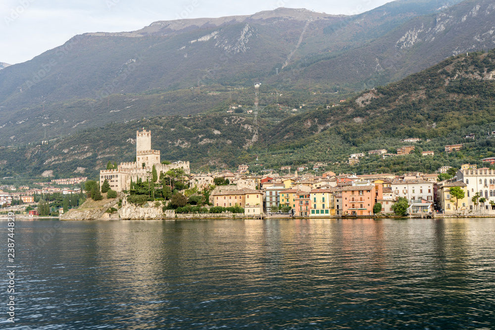 view of the old town of malcesine, in the background the monte baldo with cable car station
