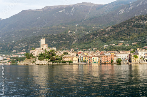 view of the old town of malcesine, in the background the monte baldo with cable car station 