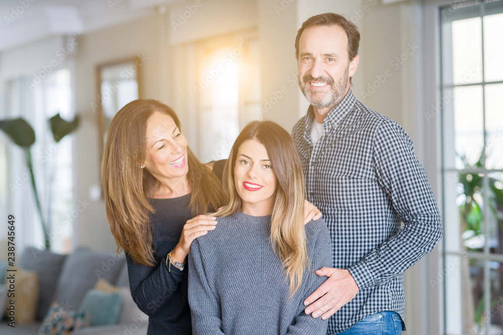 Beautiful family together. Mother, father and daughter smiling and hugging with love at home. Beautiful family together. Mother, father and daughter smiling and hugging with love at home.