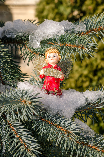 Winter angel figure red new year in the snow on the Christmas tree concept