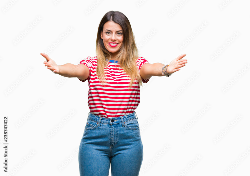 Young beautiful woman casual look over isolated background looking at the camera smiling with open arms for hug. Cheerful expression embracing happiness. Young beautiful woman casual look over isolated background looking at the camera smiling with open arms for hug. Cheerful expression embracing happiness.