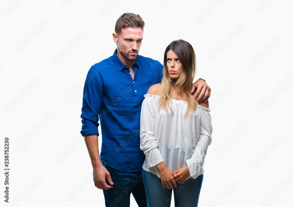 Young couple in love over isolated background skeptic and nervous, frowning upset because of problem. Negative person. Young couple in love over isolated background skeptic and nervous, frowning upset because of problem. Negative person.