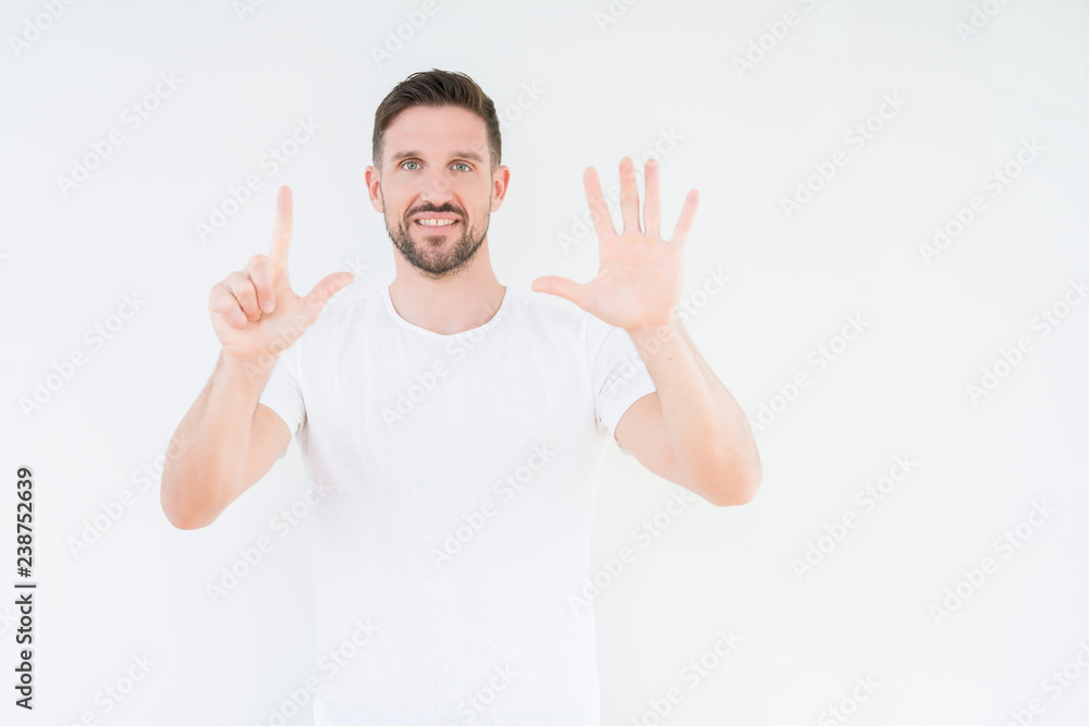 Young handsome man wearing casual white t-shirt over isolated background showing and pointing up with fingers number seven while smiling confident and happy. Young handsome man wearing casual white t-shirt over isolated background showing and pointing up with fingers number seven while smiling confident and happy.