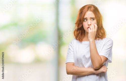 Fotografia Young beautiful woman over isolated background looking stressed and nervous with hands on mouth biting nails