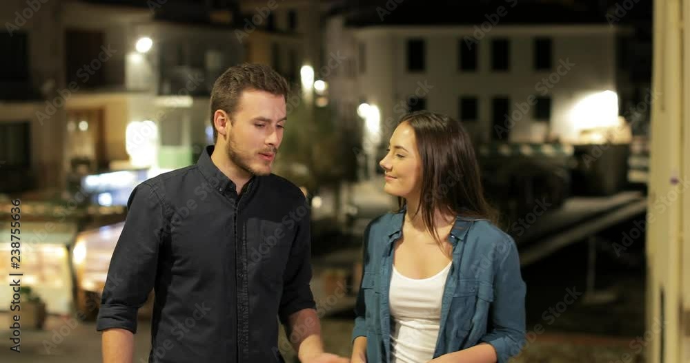 Scared girlfriend running away after marriage proposal in the street in the night Scared girlfriend running away after marriage proposal in the street in the night