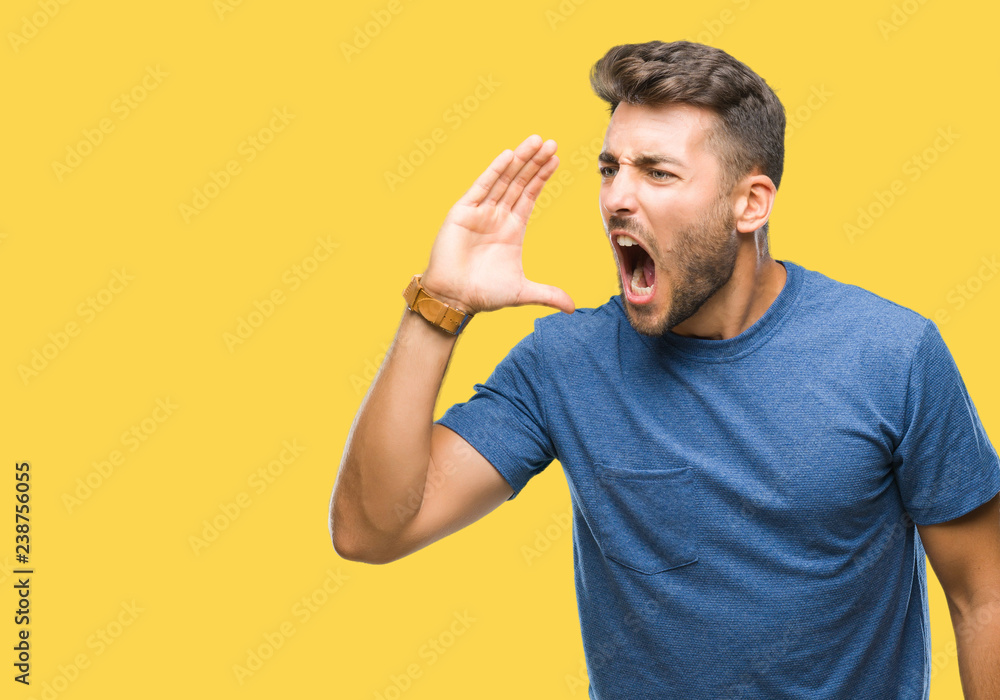 Young handsome man over isolated background shouting and screaming loud to side with hand on mouth. Communication concept. Young handsome man over isolated background shouting and screaming loud to side with hand on mouth. Communication concept.