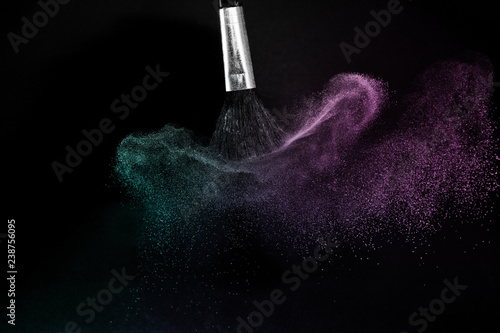 Fototapeta Naklejka Na Ścianę i Meble -  purple and blue ocean powder color splash and brush for makeup artist or graphic design in black background, look like a lively and joyful mood.
