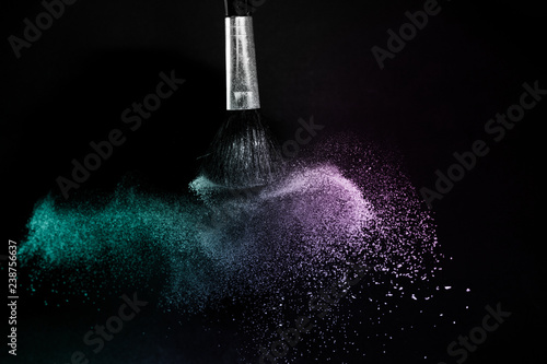 Fototapeta Naklejka Na Ścianę i Meble -  purple and blue ocean powder color splash and brush for makeup artist or graphic design in black background, look like a lively and joyful mood.