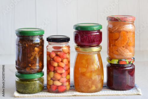 Variety of preserved food in glass jars - pickles, jam, marmalade, sauces, ketchup. Preserving vegetables and fruits. Fermented food. Autumn canning. Conservation of harvest