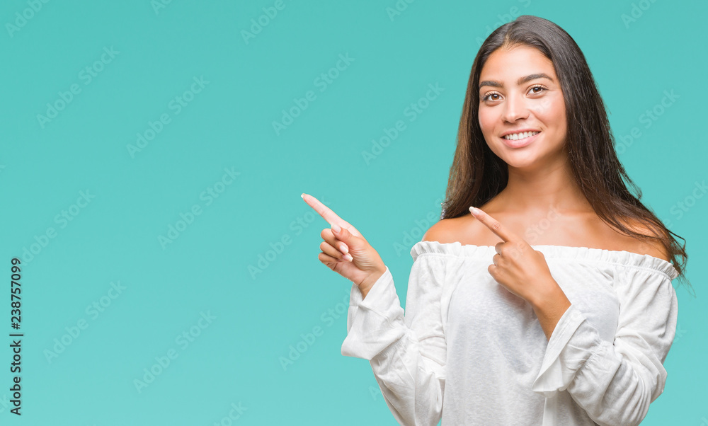 Young beautiful arab woman over isolated background smiling and looking at the camera pointing with two hands and fingers to the side. Young beautiful arab woman over isolated background smiling and looking at the camera pointing with two hands and fingers to the side.