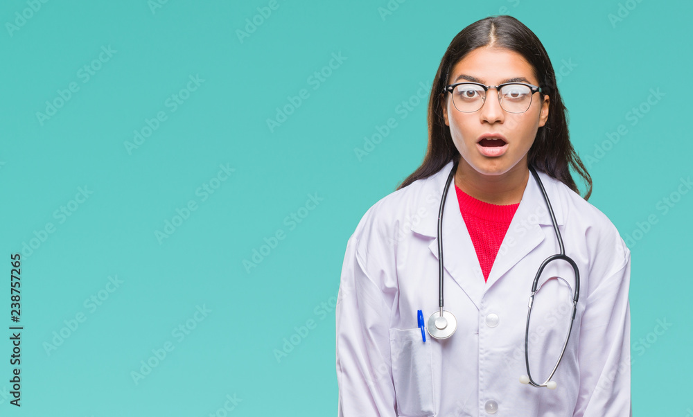 Young arab doctor woman over isolated background afraid and shocked with surprise expression, fear and excited face. Young arab doctor woman over isolated background afraid and shocked with surprise expression, fear and excited face.