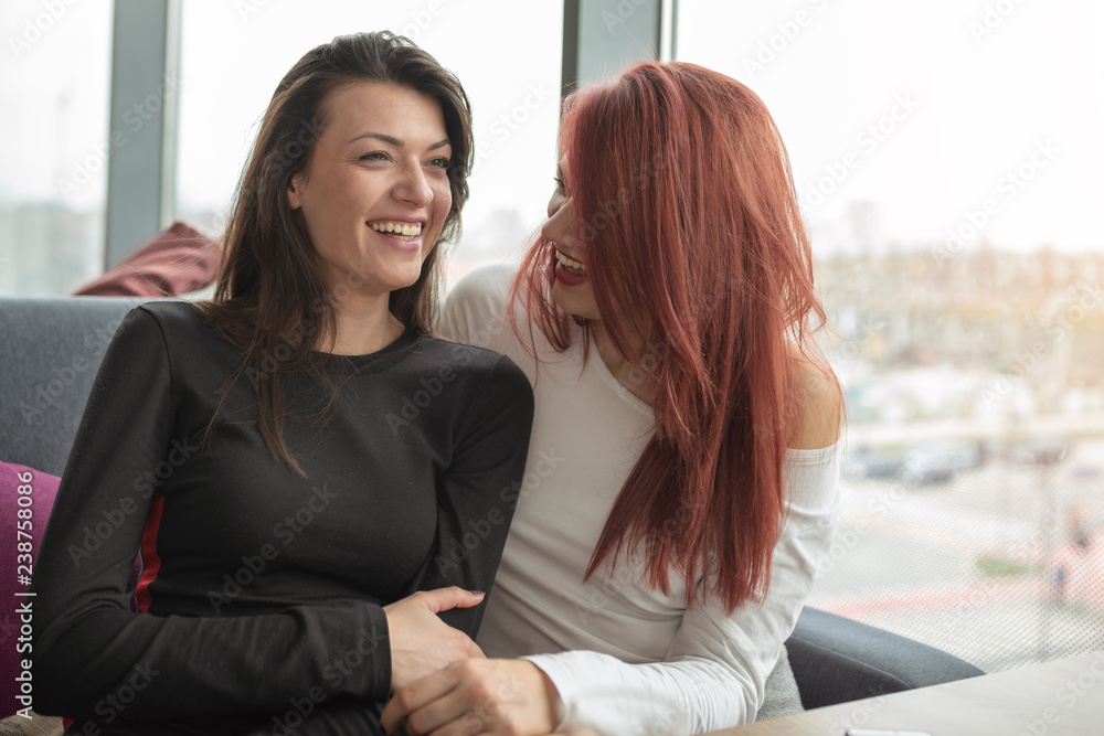 Two young pretty women at coffee shop, girls talk. Two young pretty women at coffee shop, girls talk.
