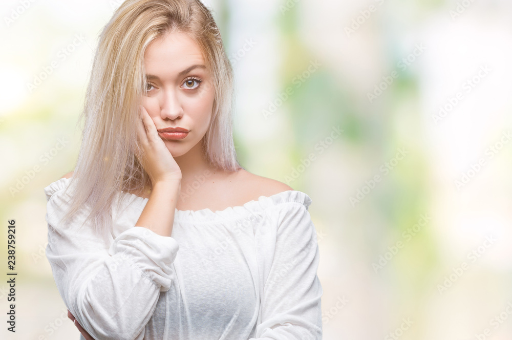 Young blonde woman over isolated background thinking looking tired and bored with depression problems with crossed arms. Young blonde woman over isolated background thinking looking tired and bored with depression problems with crossed arms.
