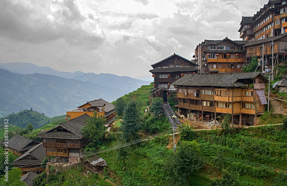 Chinese village in the beautiful terraced rice fields in Longsheng. Tian Tou Zhai village in longji rice terrace in guangxi province of China. Chinese village in the beautiful terraced rice fields in Longsheng. Tian Tou Zhai village in longji rice terrace in guangxi province of China.
