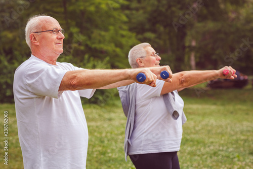 Senior exercise - Elderly man exercising with dumbbells.