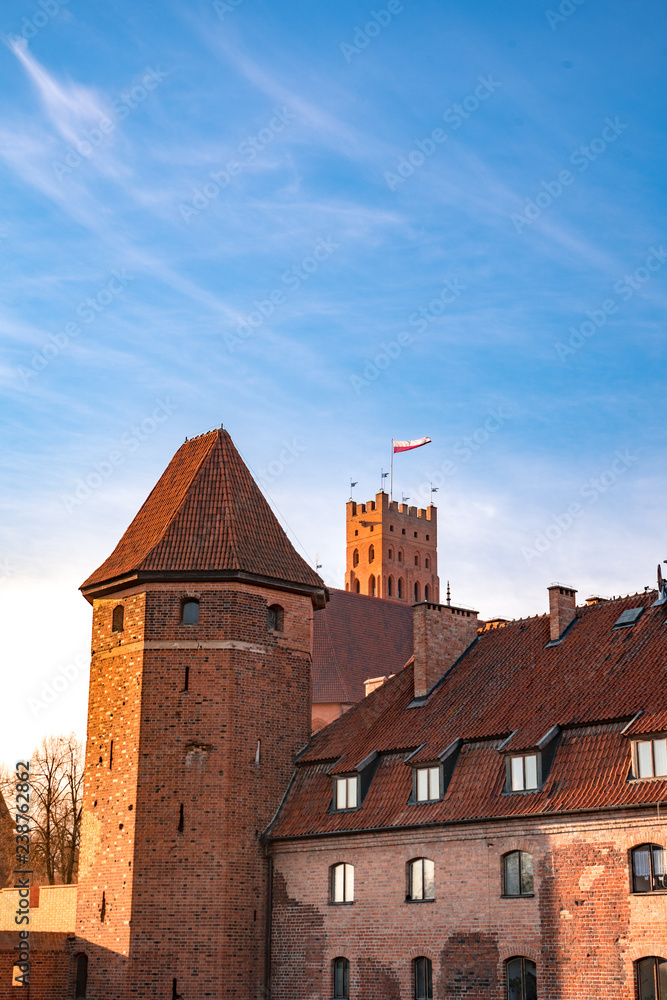 Polish national flag flying over medieval Teutonic knights castle in Malbork Polish national flag flying over medieval Teutonic knights castle in Malbork