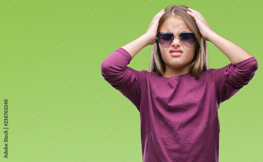 Young beautiful girl wearing sunglasses over isolated background suffering from headache desperate and stressed because pain and migraine. Hands on head. Young beautiful girl wearing sunglasses over isolated background suffering from headache desperate and stressed because pain and migraine. Hands on head.