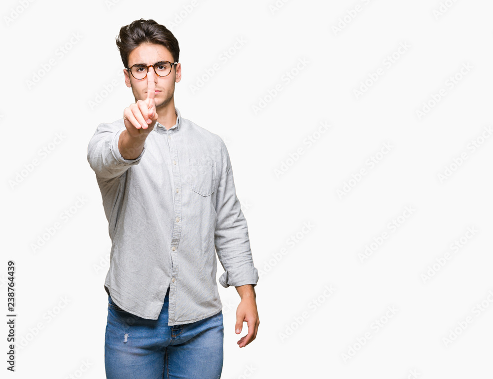 Young handsome man wearing glasses over isolated background Pointing with finger up and angry expression Young handsome man wearing glasses over isolated background Pointing with finger up and angry expression