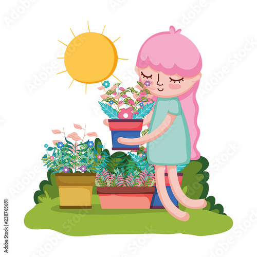 little girl lifting houseplant in the garden