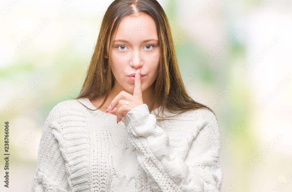 Young beautiful caucasian woman wearing winter sweater over isolated background asking to be quiet with finger on lips. Silence and secret concept. Young beautiful caucasian woman wearing winter sweater over isolated background asking to be quiet with finger on lips. Silence and secret concept.