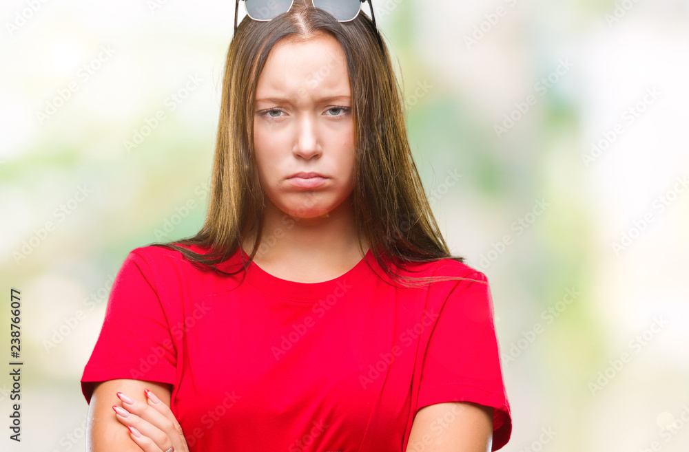 Young beautiful caucasian woman wearing sunglasses over isolated background skeptic and nervous, disapproving expression on face with crossed arms. Negative person.