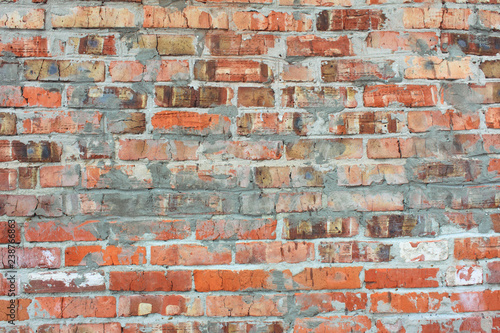Old red brick brick wall with cement stains