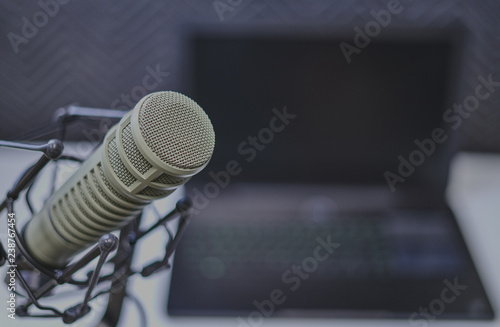 Podcast recording microphone with laptop