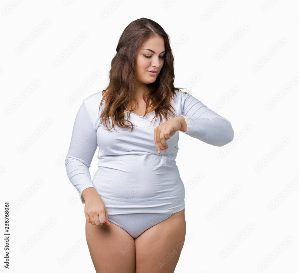 Beautiful plus size young overwight woman wearing white underwear over isolated background Checking the time on wrist watch, relaxed and confident Beautiful plus size young overwight woman wearing white underwear over isolated background Checking the time on wrist watch, relaxed and confident