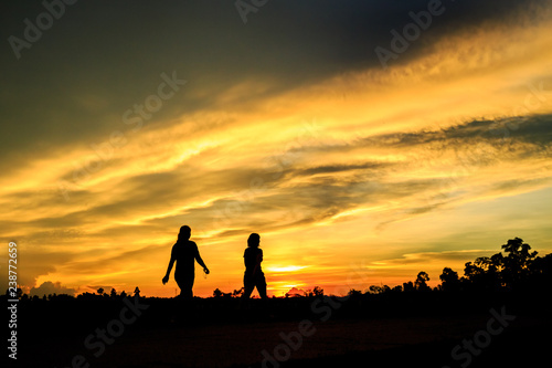 silhouette of man and woman at sunset