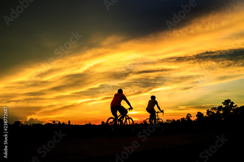 silhouette of cyclist on background of sunset