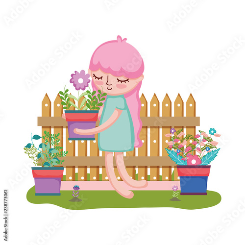 girl lifting houseplant with fence in the garden