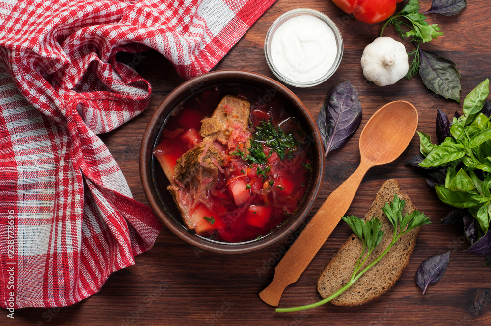 Traditional national soup 'Ukrainian borsch'. Nearby bread, garlic, basil and spoon. Delicious healthy home food Traditional national soup 'Ukrainian borsch'. Nearby bread, garlic, basil and spoon. Delicious healthy home food
