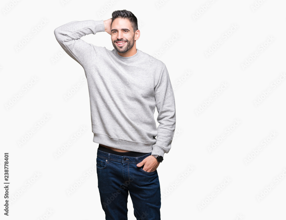 Young handsome man wearing sweatshirt over isolated background Smiling confident touching hair with hand up gesture, posing attractive Young handsome man wearing sweatshirt over isolated background Smiling confident touching hair with hand up gesture, posing attractive