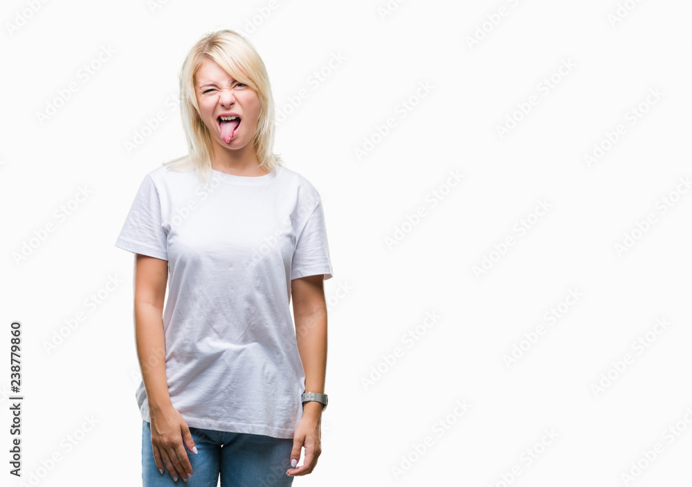 Fototapeta premium Young beautiful blonde woman wearing white t-shirt over isolated background sticking tongue out happy with funny expression. Emotion concept.