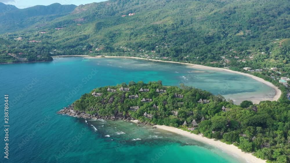 Aerial view of tropical paradise with white sand beaches Anse Louis and Anse Boileau, crystal clear waters of Indian Ocean, lush green tropical forest of Mahe Island - Seychelles Aerial view of tropical paradise with white sand beaches Anse Louis and Anse Boileau, crystal clear waters of Indian Ocean, lush green tropical forest of Mahe Island - Seychelles