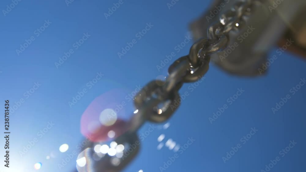 Water running down a stainless steel link chain Water running down a stainless steel link chain