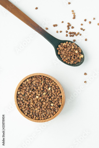 buckwheat in wooden spoon and bowle