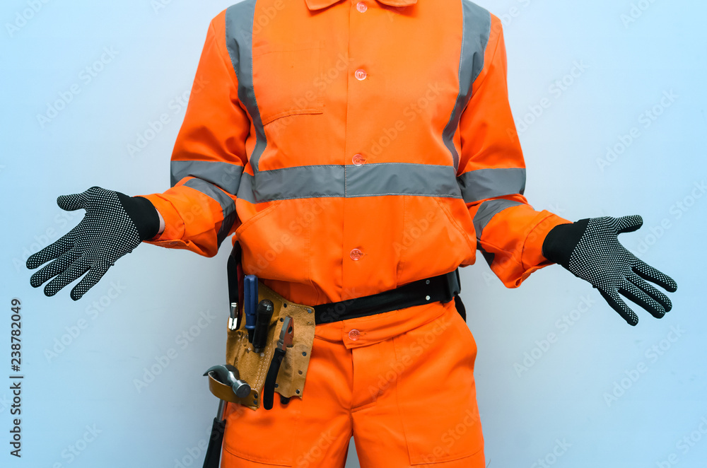 Guilty builder worker justifies and spreads his hands isolated on blue background. Construction mistake. Refusal to building contract. Guilty builder worker justifies and spreads his hands isolated on blue background. Construction mistake. Refusal to building contract.