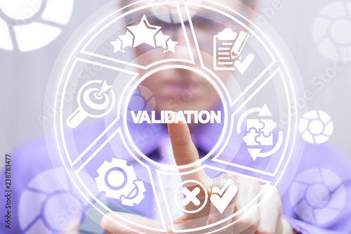 Validation business concept. Man pushing a validation word button on a virtual round interface. photo
