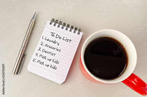 To Do List text on note pad cup of coffee and pen.