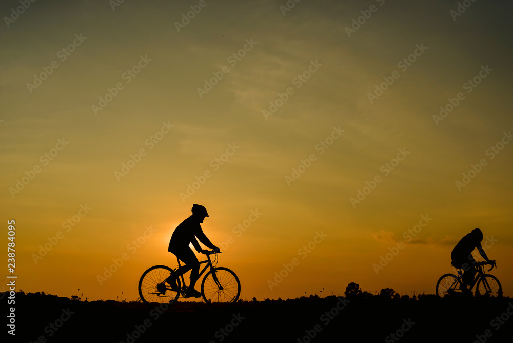 Fototapeta premium Man ride bicycle on sunset background