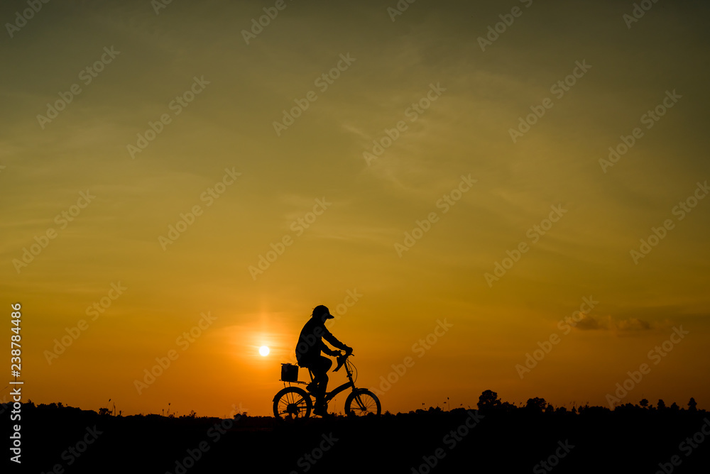 silhouette of cyclist at sunset