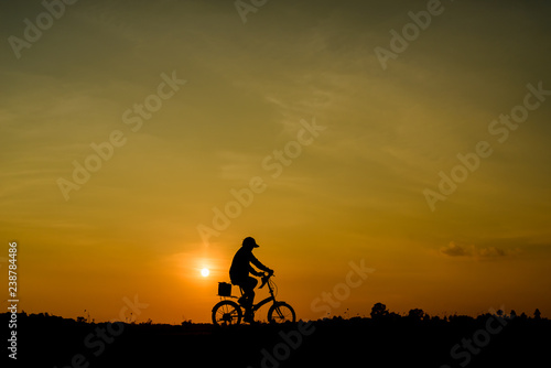 silhouette of cyclist at sunset