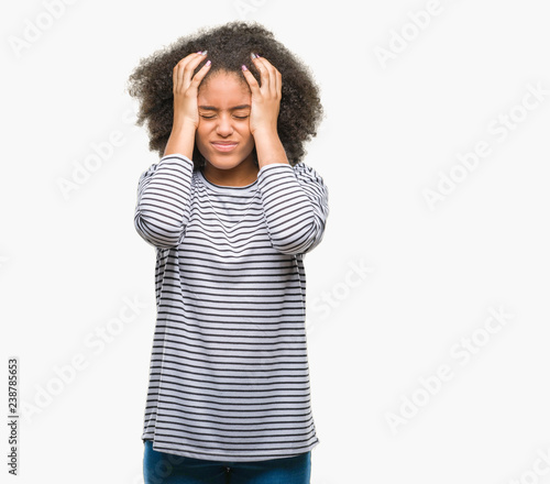 Young afro american woman over isolated background suffering from headache desperate and stressed because pain and migraine. Hands on head.