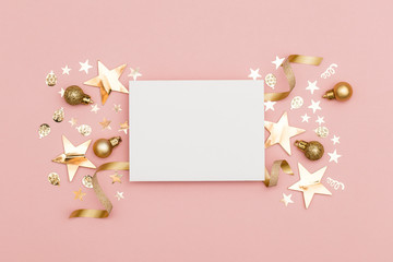 Gold Christmas cracker with a blank white label. luxury gold festive cracker on a pastel pink background