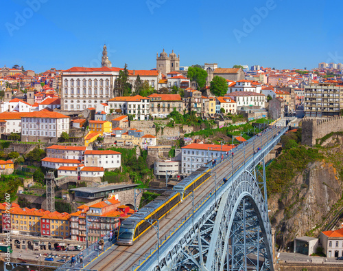 View of the historic city of Porto and Luis I Bridge with Metro train in the sunny day, Portugal. photo