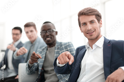 group of successful young men pointing their fingers at you