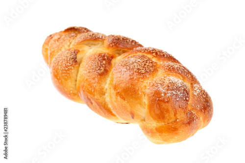 Traditional Bulgarian sweet leavened bread Kozunak, braided and sprinkled with sugar, isolated on white. In Bulgaria Kozunak is mainly prepared for Easter, but can be found in bakeries year round