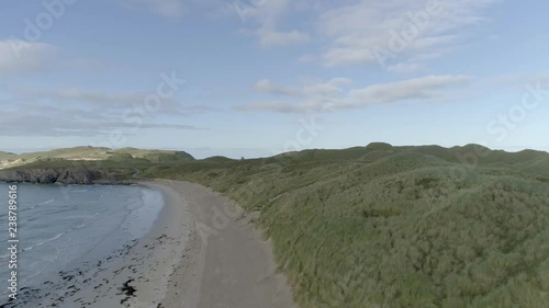 Elevating drone shot of a surf beach at Faraid Head on the north coast of Scotland photo